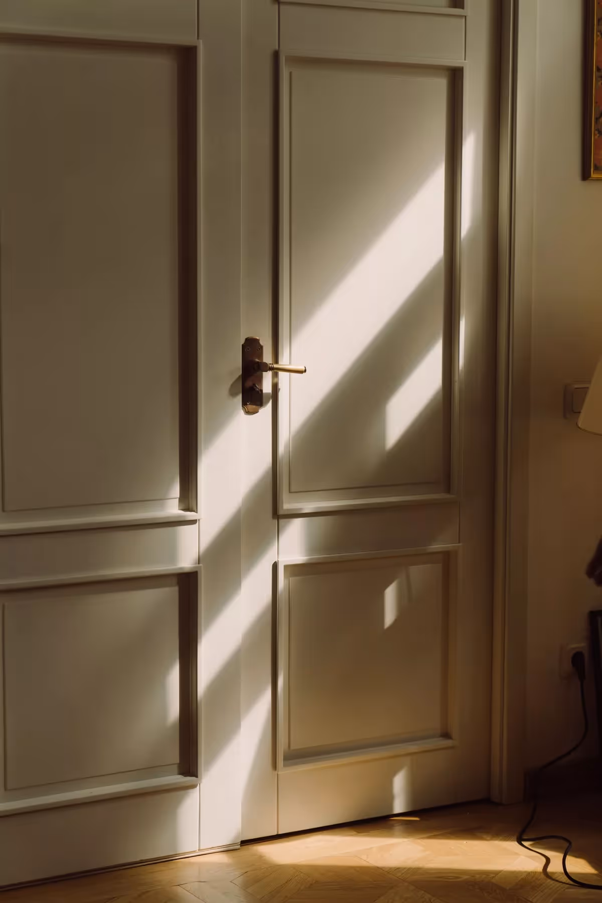 Afternoon light falling across a paneled door inside a quiet office